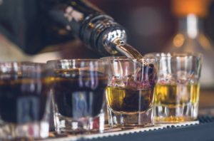 close-up of drinks being poured at a bar