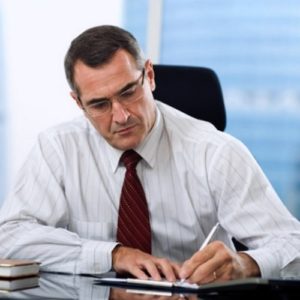 man wearing red tie while working in the office